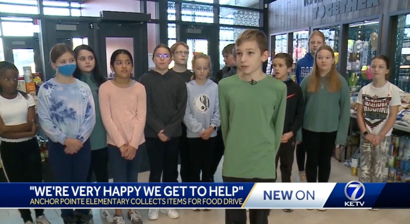 Students from Anchor Pointe Elementary School gather in front of the camera screenshot from KETV's coverage of the story