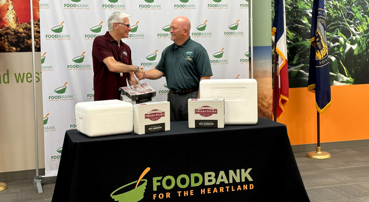 Photo of Brian Barks, President and CEO of Food Bank for the Heartland shaking hands with CEO of Omaha Steaks, Todd Simon