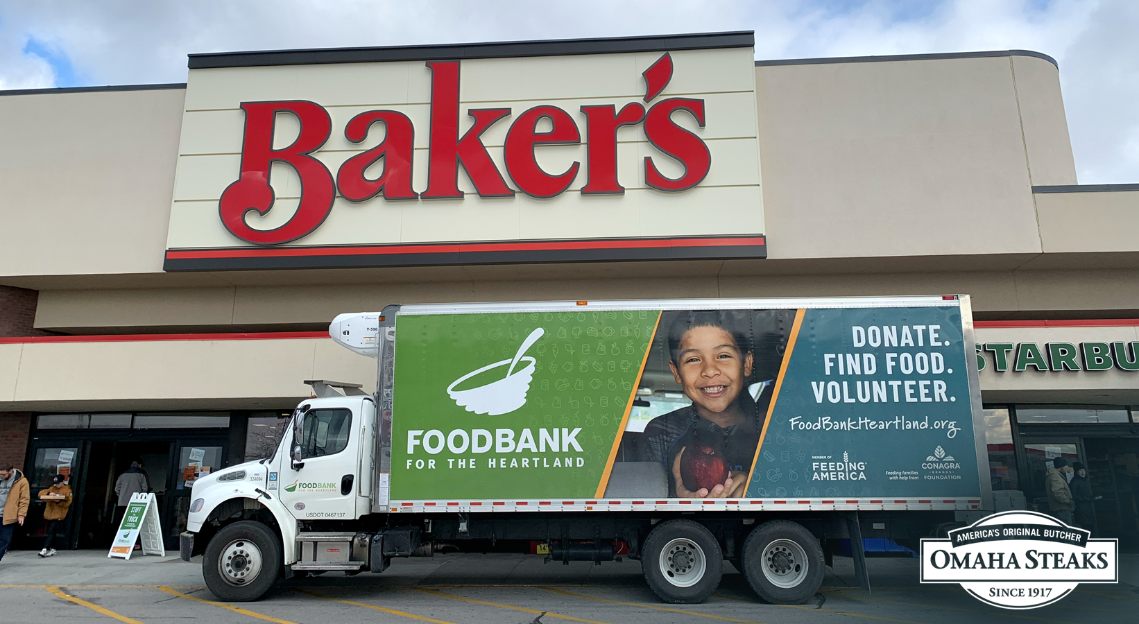 Photo of Food Bank for the Heartland straight truck in front of Baker's with Omaha Steaks logo