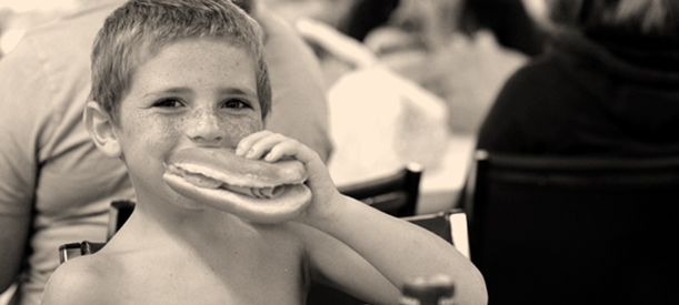 Photo of boy eating a sandwich