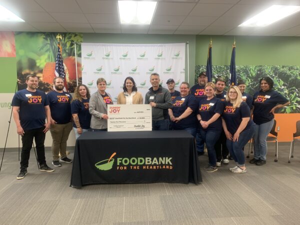 Dunkin' employees present check to the Food Bank.